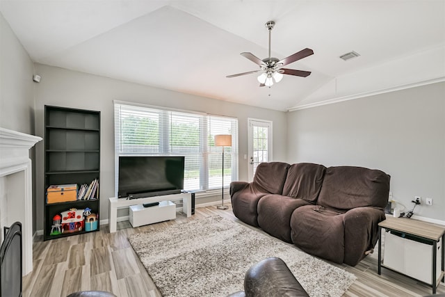 living room featuring vaulted ceiling, ceiling fan, and light wood-type flooring