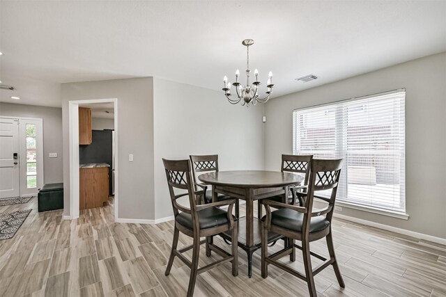 dining area featuring wood finish floors, baseboards, a chandelier, and recessed lighting