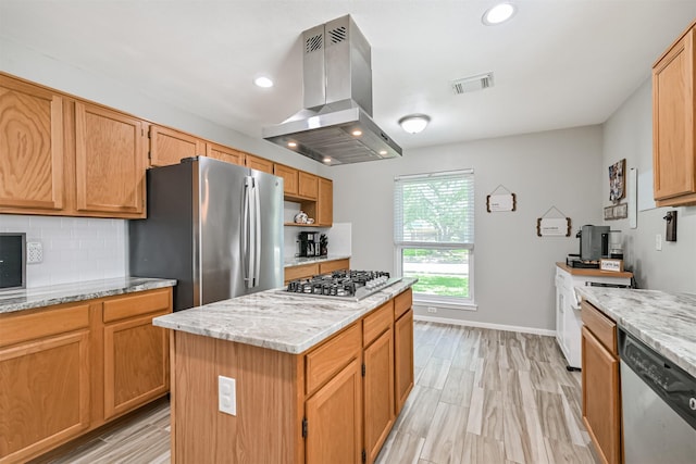 kitchen featuring island range hood, stainless steel appliances, tasteful backsplash, light stone countertops, and recessed lighting