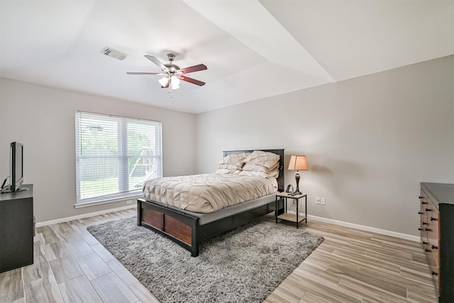 bedroom with baseboards, light wood finished floors, and ceiling fan