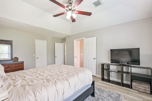 bedroom featuring wood finished floors, a ceiling fan, and baseboards
