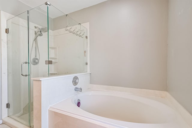 full bathroom featuring a shower stall and a bath