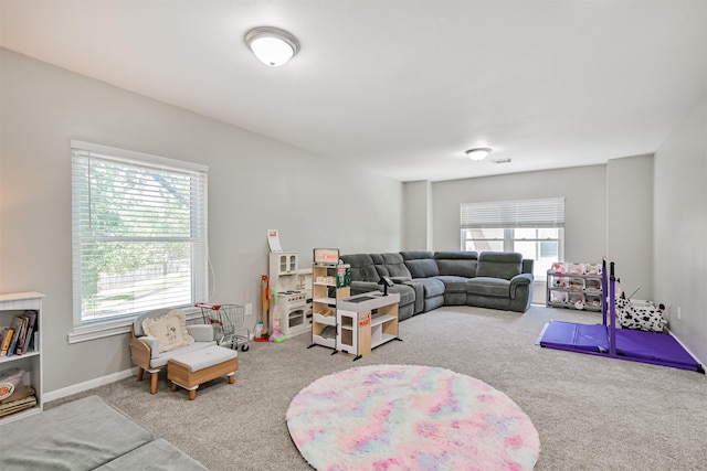 living area featuring carpet flooring and baseboards