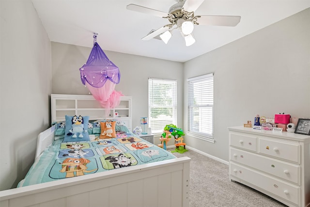 bedroom with light carpet, baseboards, and ceiling fan