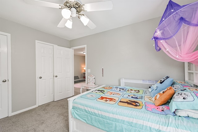 carpeted bedroom featuring ceiling fan and baseboards