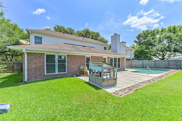 rear view of house with a patio area and brick siding