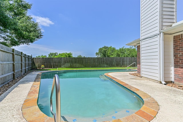 view of swimming pool with a fenced backyard