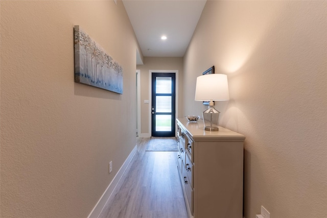 doorway to outside with baseboards, light wood-style flooring, and recessed lighting