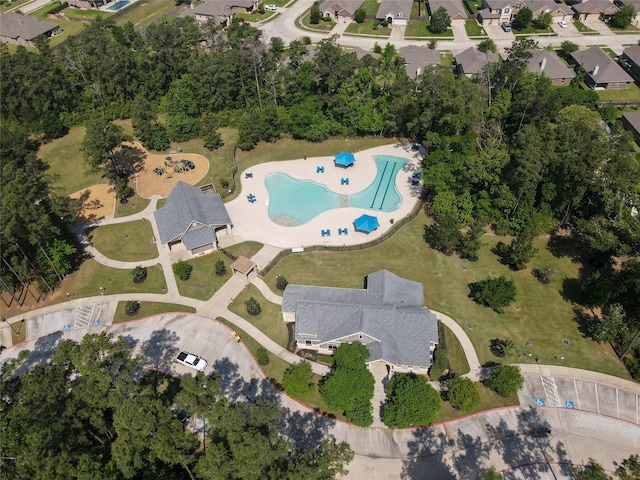 view of property location with a pool and nearby suburban area
