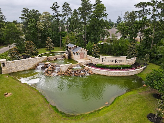 view of community with a hot tub and a yard