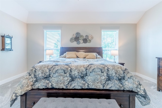 bedroom with carpet floors, baseboards, and vaulted ceiling