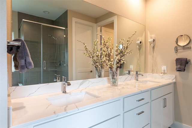 full bath with a shower stall and double vanity