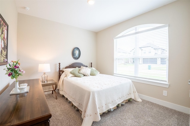 bedroom featuring baseboards and carpet