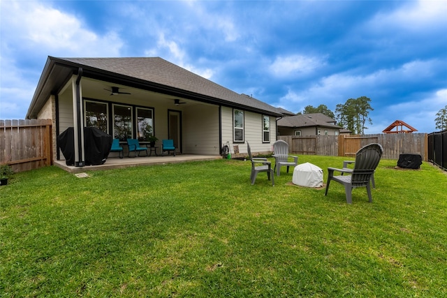 back of property with ceiling fan and a patio area