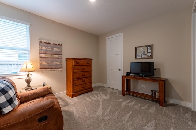 sitting room featuring carpet floors and baseboards