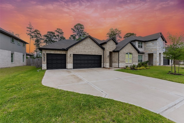 french country inspired facade featuring a garage, concrete driveway, stone siding, brick siding, and roof with shingles