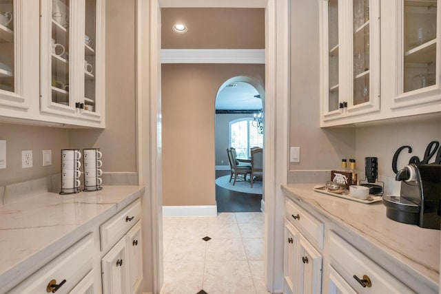 12710 Everhart Pointe Dr, Tomball, TX 77377 - bar with arched walkways, light tile patterned flooring, recessed lighting, and ornamental molding