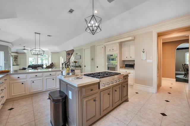 12710 Everhart Pointe Dr, Tomball, TX 77377 - kitchen with appliances with stainless steel finishes, open floor plan, light tile patterned flooring, pendant lighting, and a chandelier