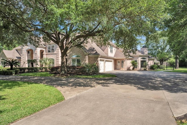 12710 Everhart Pointe Dr, Tomball, TX 77377 - view of front facade with driveway, brick siding, a chimney, and an attached garage