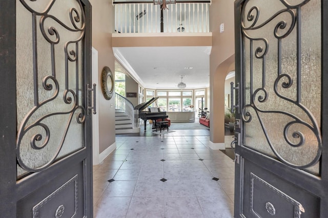 12710 Everhart Pointe Dr, Tomball, TX 77377 - foyer featuring baseboards, light tile patterned flooring, stairway, and a towering ceiling