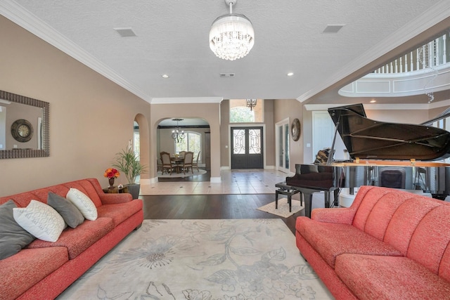 12710 Everhart Pointe Dr, Tomball, TX 77377 - living room featuring a chandelier, arched walkways, wood finished floors, baseboards, and recessed lighting