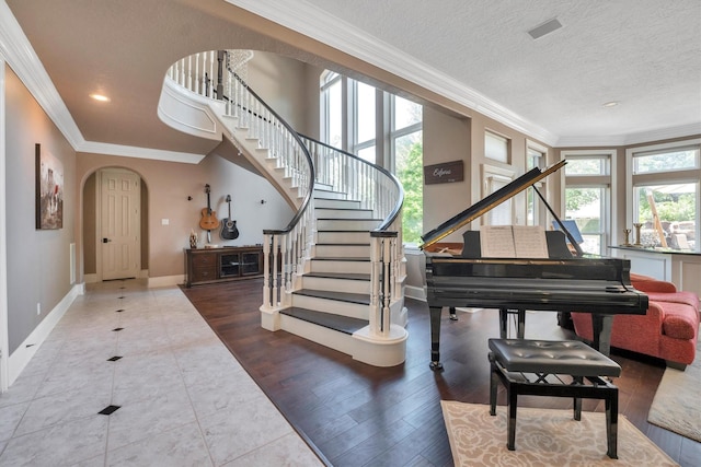 12710 Everhart Pointe Dr, Tomball, TX 77377 - entryway featuring arched walkways, stairs, crown molding, baseboards, and recessed lighting