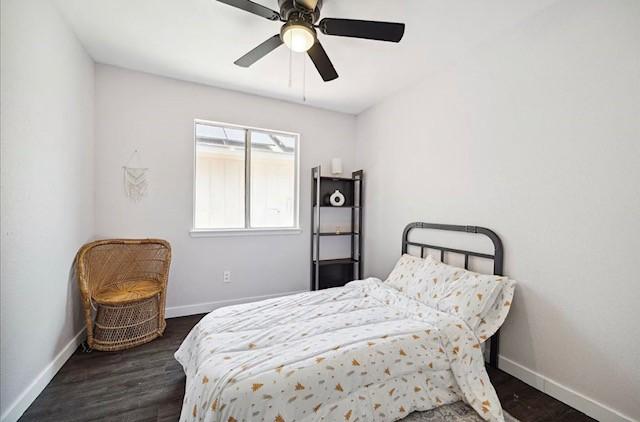 3734 Varla Ln, Houston, TX 77014 - bedroom with baseboards, dark wood-style floors, and a ceiling fan