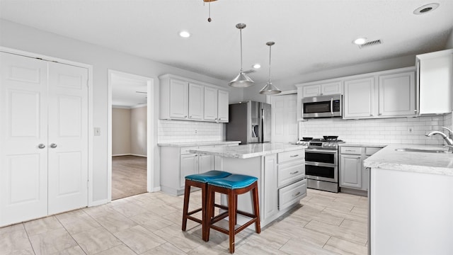 16902 River Willow Dr, Spring, TX 77379 - kitchen with stainless steel appliances, a sink, a center island, recessed lighting, and tasteful backsplash