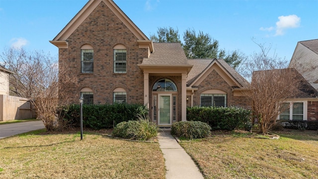 16902 River Willow Dr, Spring, TX 77379 - traditional-style home featuring brick siding and roof with shingles