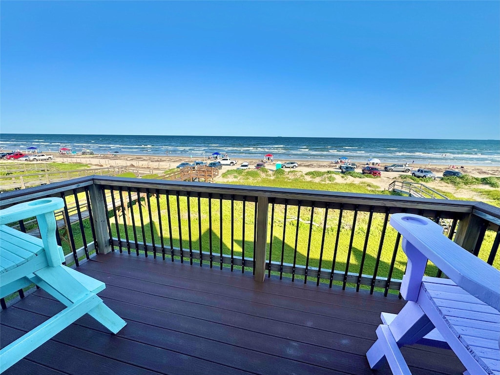 101 Pelican Pl Unit 3, Surfside Beach, TX 77541 - wooden deck featuring view of water and beach