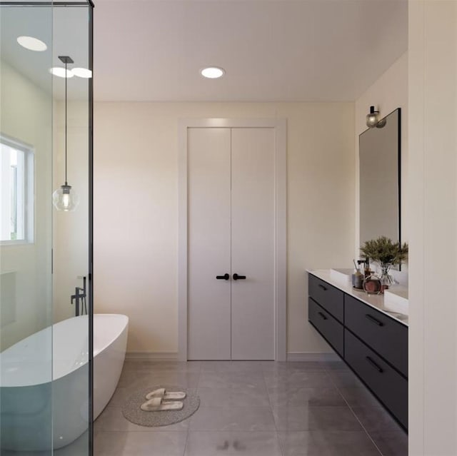 6541 Sealey St, Houston, TX 77091 - bathroom with a soaking tub, tile patterned floors, baseboards, and vanity