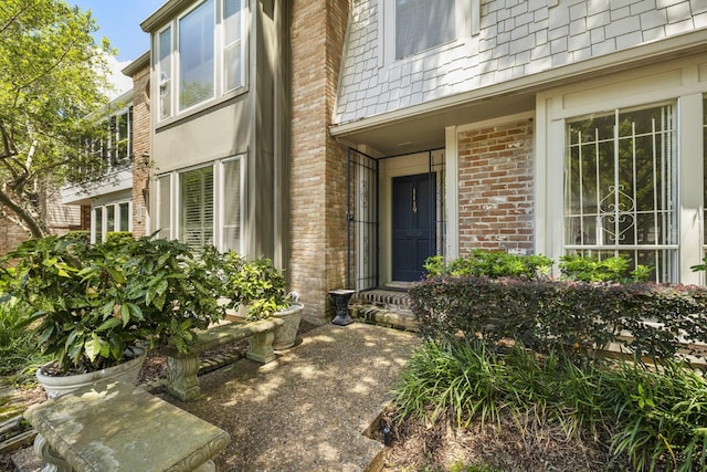 view of exterior entry with brick siding