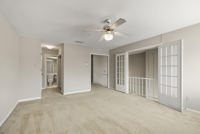 empty room featuring a ceiling fan, carpet flooring, and baseboards