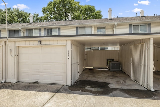 garage featuring cooling unit and concrete driveway