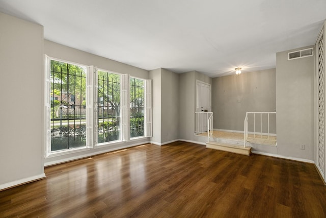 unfurnished room featuring wood finished floors and baseboards