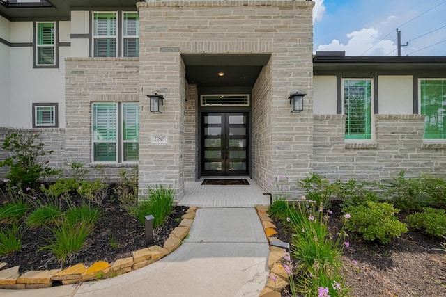 27807 Bridgeway St, Spring, TX 77386 - property entrance featuring french doors, stone siding, and stucco siding