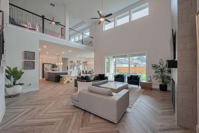 27807 Bridgeway St, Spring, TX 77386 - living room with ceiling fan, a high ceiling, a fireplace, and baseboards