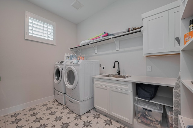 27807 Bridgeway St, Spring, TX 77386 - clothes washing area featuring light floors, washing machine and dryer, cabinet space, and baseboards