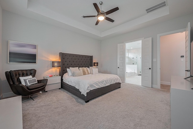 27807 Bridgeway St, Spring, TX 77386 - carpeted bedroom with a raised ceiling, ensuite bath, baseboards, and a ceiling fan