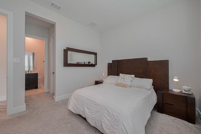 27807 Bridgeway St, Spring, TX 77386 - bedroom with light carpet, baseboards, and ensuite bathroom