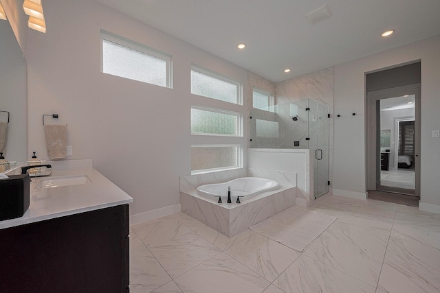27807 Bridgeway St, Spring, TX 77386 - full bathroom with marble look tile flooring, a garden tub, a shower stall, recessed lighting, and baseboards