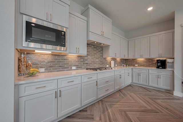 27807 Bridgeway St, Spring, TX 77386 - kitchen with stainless steel appliances, light countertops, tasteful backsplash, recessed lighting, and white cabinets