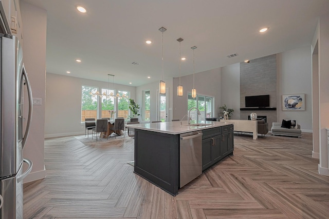 27807 Bridgeway St, Spring, TX 77386 - kitchen with open floor plan, a sink, stainless steel appliances, light countertops, and baseboards