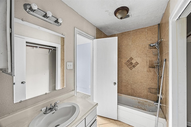 17607 Northfalk Dr, Houston, TX 77084 - bathroom featuring vanity, bathing tub / shower combination, tile patterned floors, and a textured ceiling