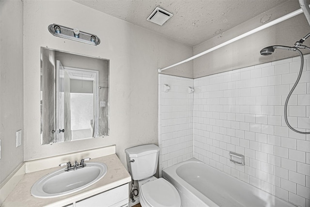 17607 Northfalk Dr, Houston, TX 77084 - full bathroom featuring toilet, a textured ceiling, vanity, and shower / tub combination