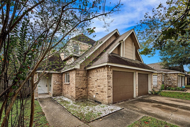 17607 Northfalk Dr, Houston, TX 77084 - view of front of home with a garage, brick siding, and a shingled roof