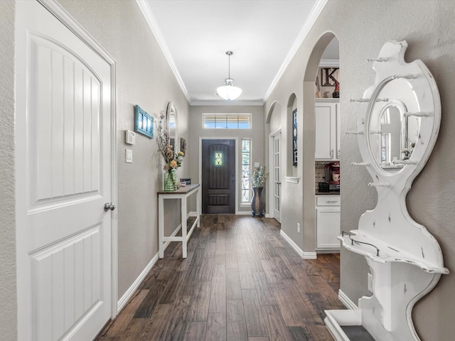1326 Tee Time Ct, Crosby, TX 77532 - foyer entrance featuring crown molding, dark wood-style floors, arched walkways, and baseboards