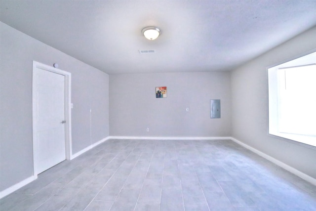 6534 Ledbetter St, Houston, TX 77087 - unfurnished room with baseboards, electric panel, and light wood-type flooring