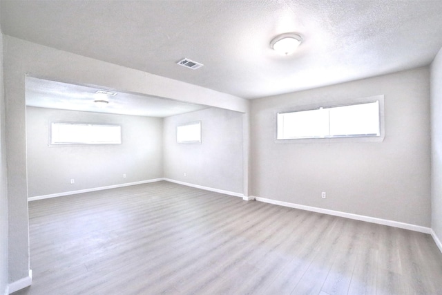6534 Ledbetter St, Houston, TX 77087 - below grade area with wood finished floors, baseboards, and a textured ceiling