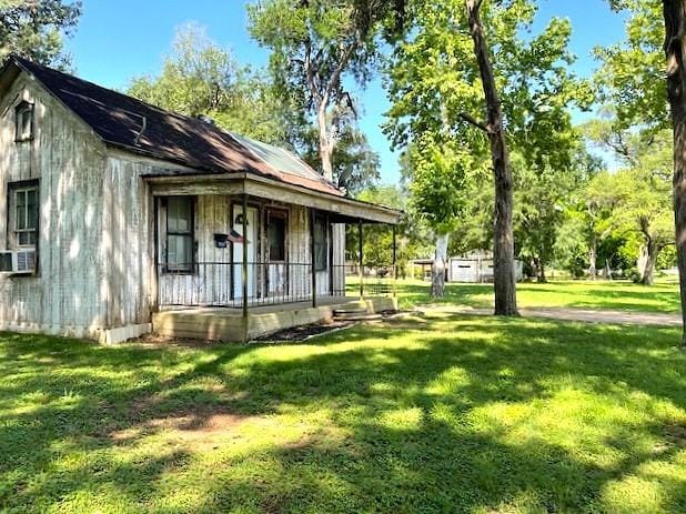 6211 Gresham St, Wallis, TX 77485 - view of property exterior with a porch, a yard, and cooling unit